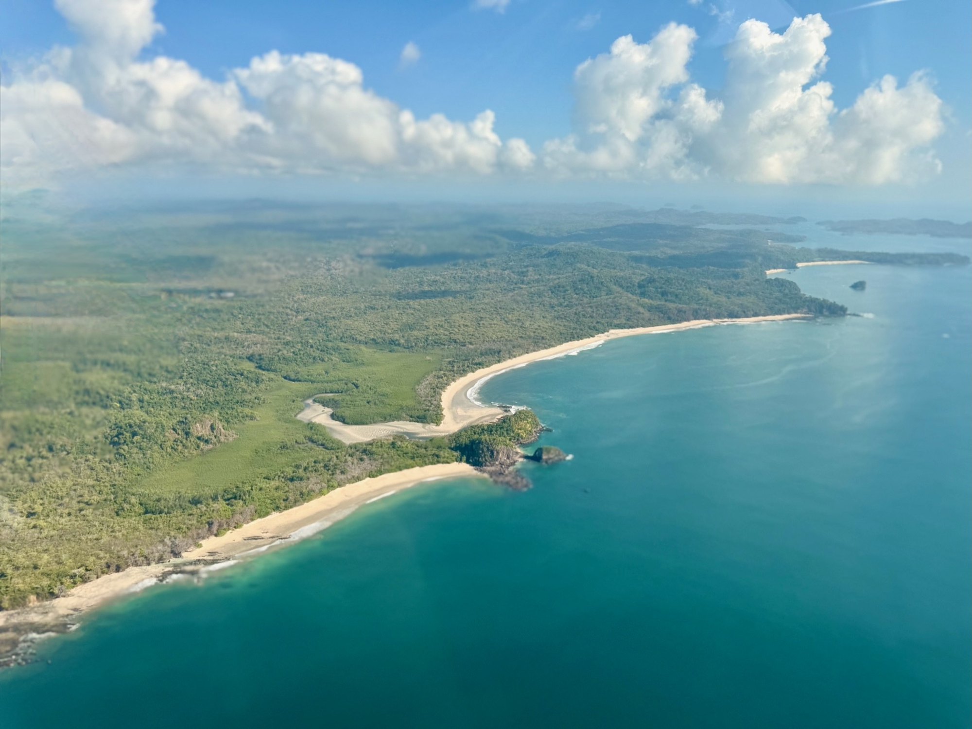 The Pacific coast of Isla del Rey running away towards the Pearl Archipelago, forest behind every beach